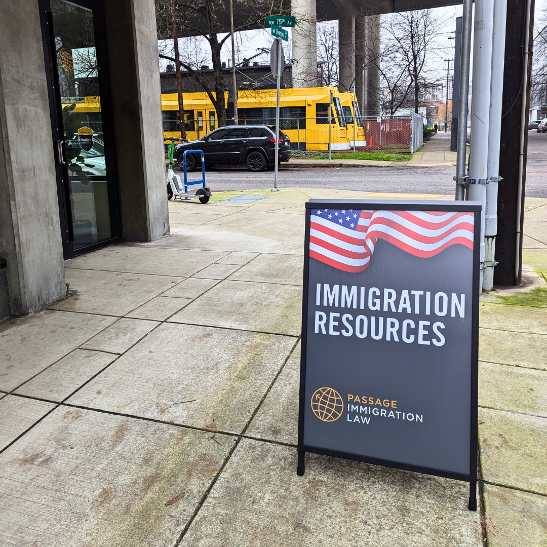 Sandwich board sign right outside the entrance of Passage Immigration's new office in the Pearl announcing "Immigration Resources" here.