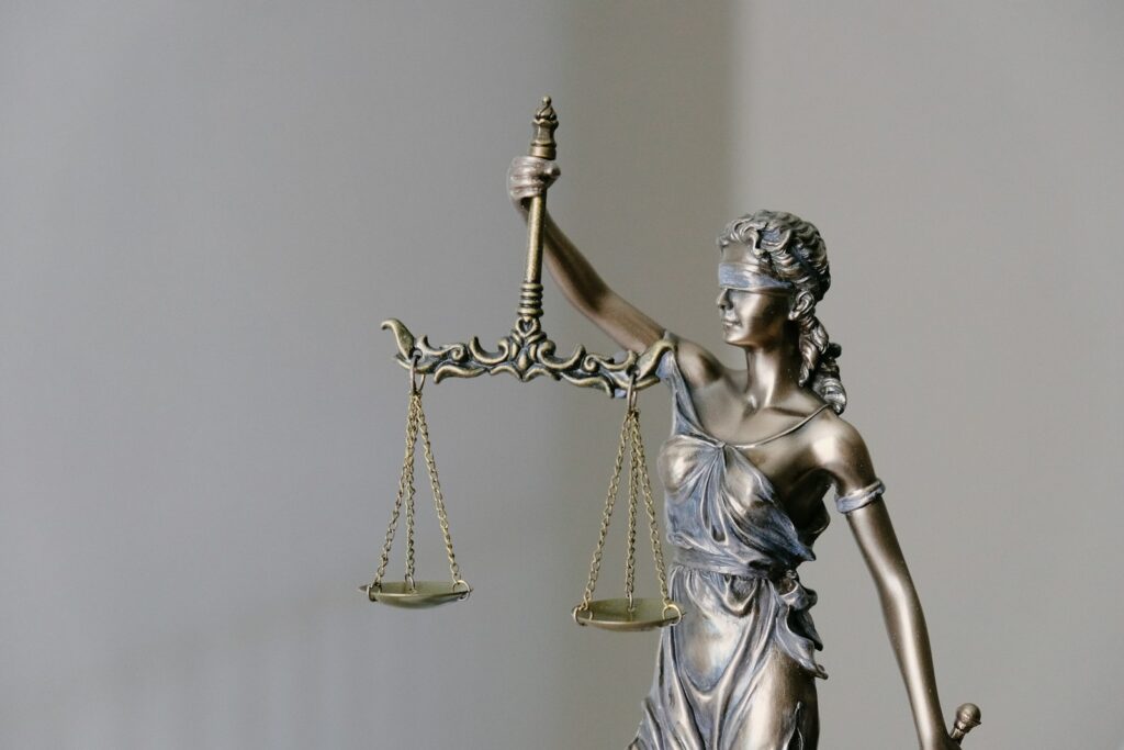Lady Justice statue holding scales — symbol of the Good Moral Character standard for naturalization
